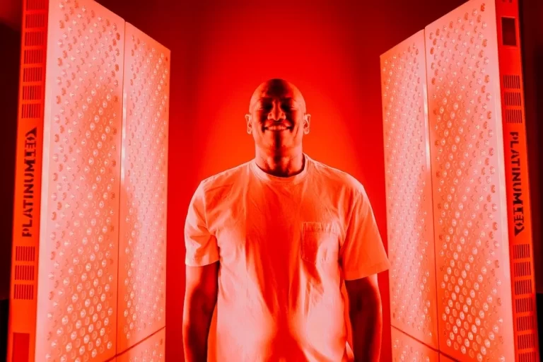 Man smiling while enjoying Red Light Therapy at Restore Hyper Wellness