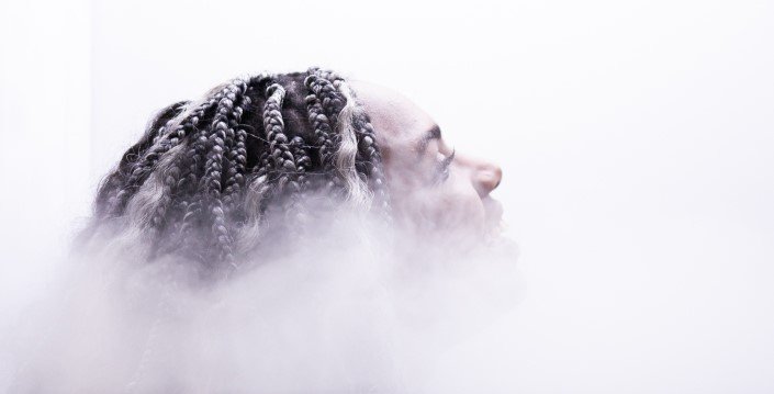 A woman with dreadlocks enjoying Cryotherapy at Restore Hyper Wellness