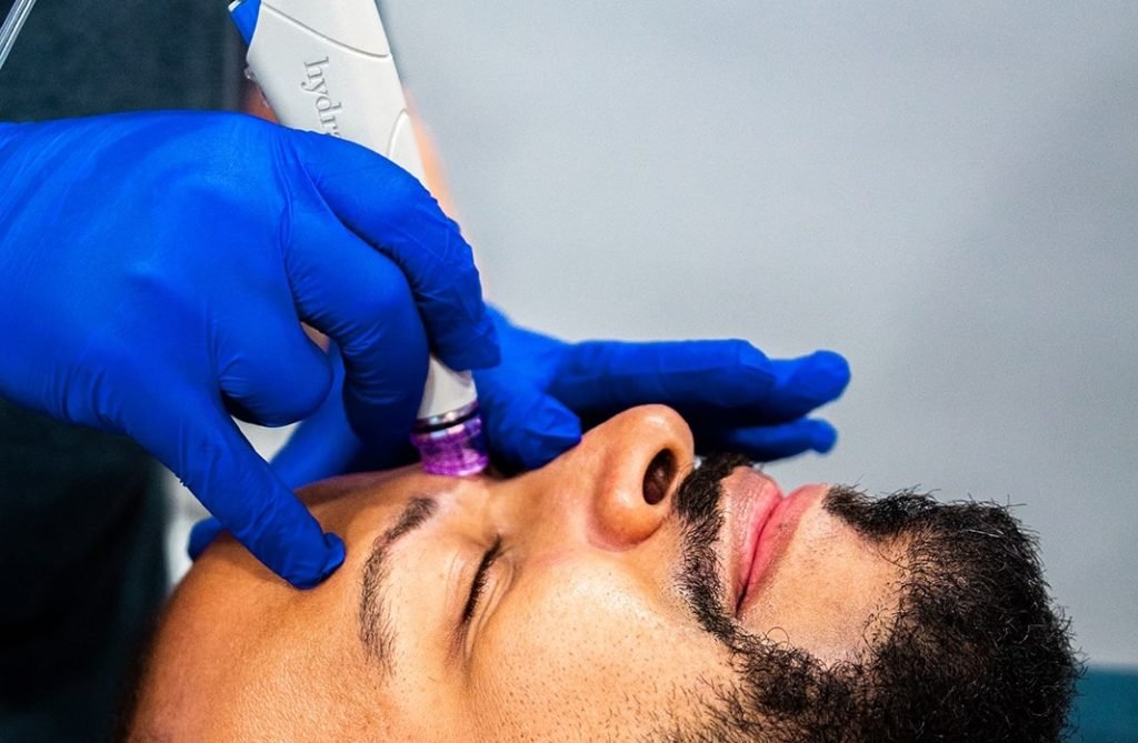 Man receiving HydraFacial treatment at Restore Hyper Wellness North Mt Pleasant