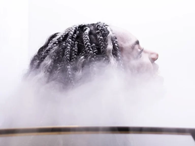 A woman with dreadlocks enjoying Cryotherapy at Restore Hyper Wellness