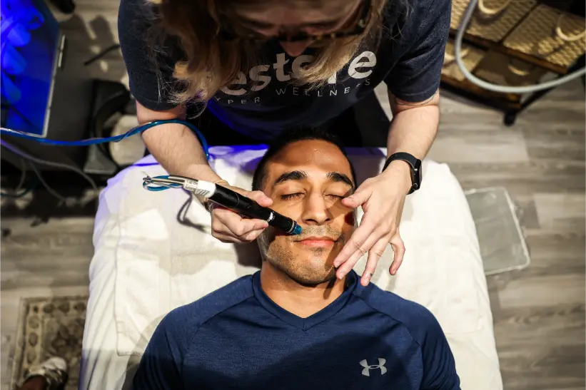 a young men getting hydra facial treatment.