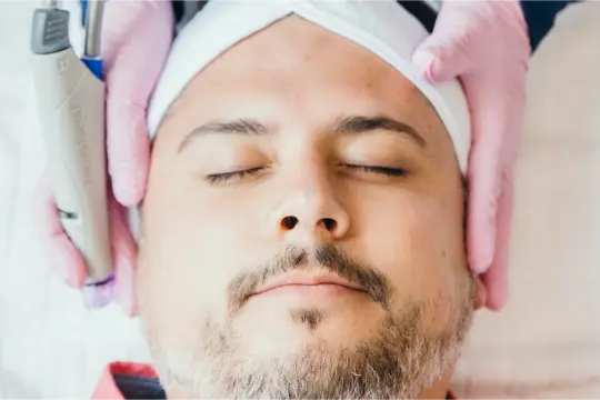 a man getting getting prepared for a hydra facial treatment.