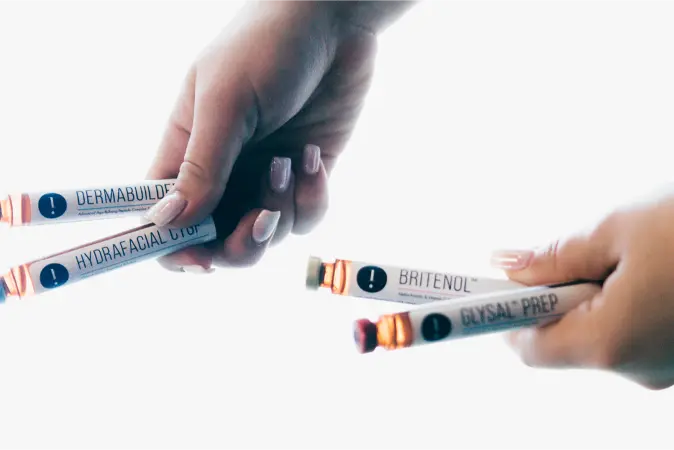 a close up of someone holding vials.