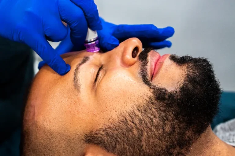 a close up of a man enjoying a hydra facial.