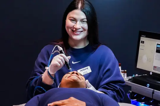 two women smiling during a procedure.