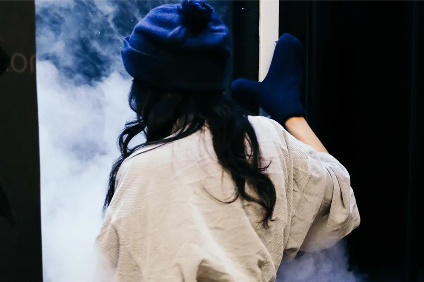 a woman about to enter a cryotherapy chamber.